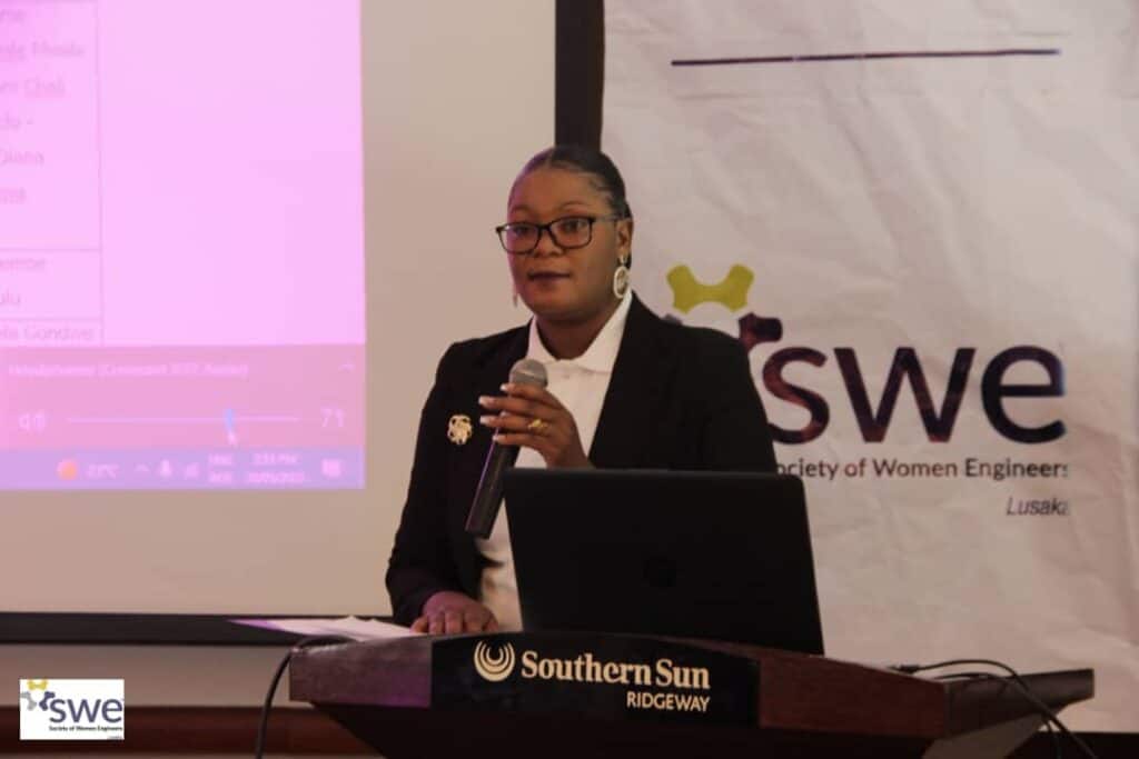 woman in suit holding microphone