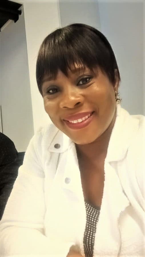 woman smiling in white blazer