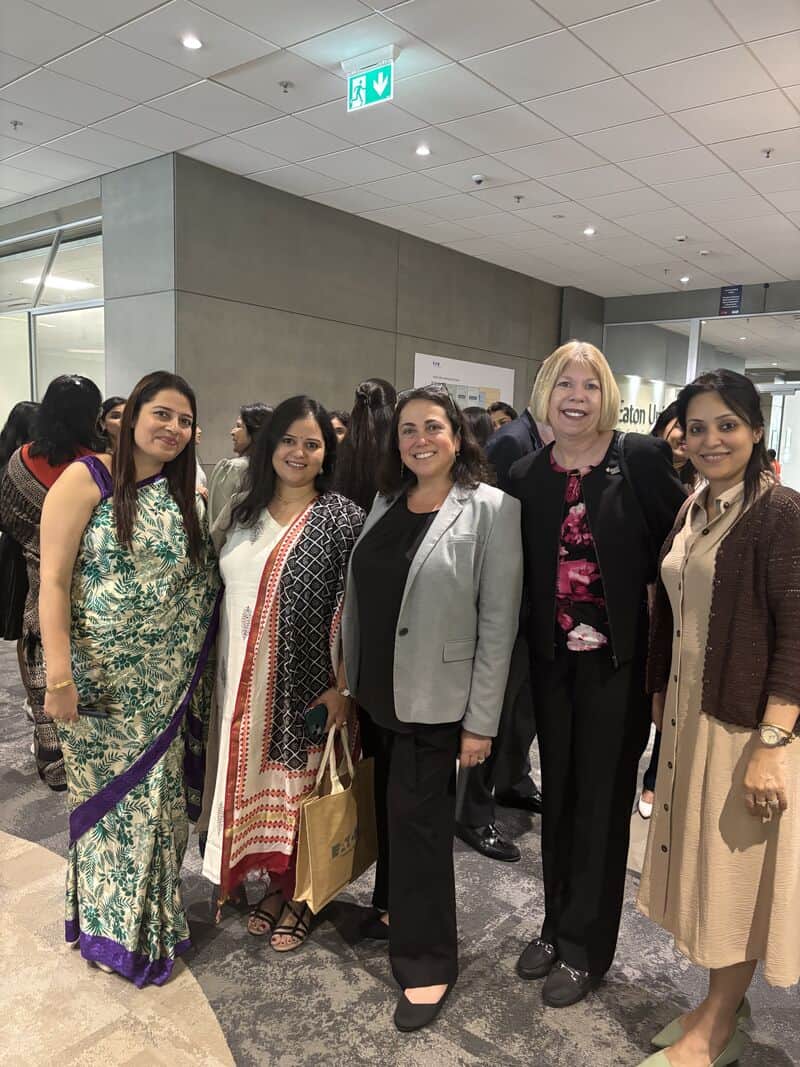 five smiling women at an event in India