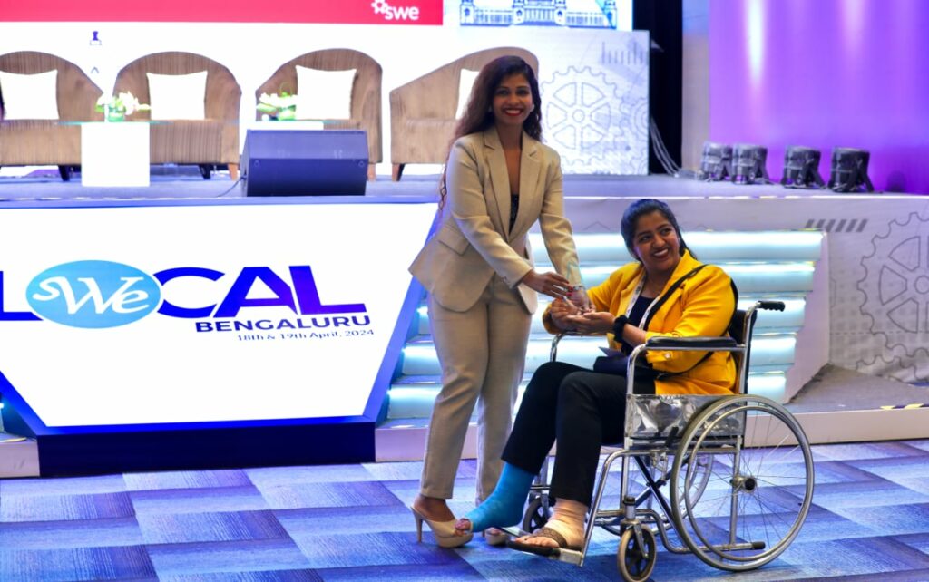 Woman receiving recognition at conference
