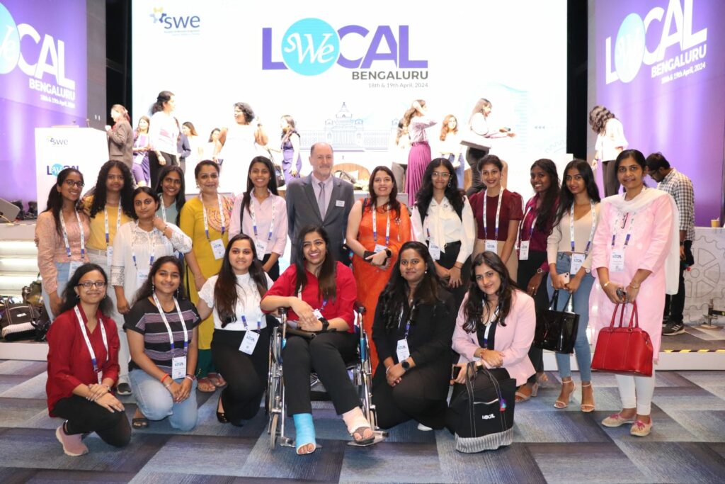 Group posing in front of the stage at conference